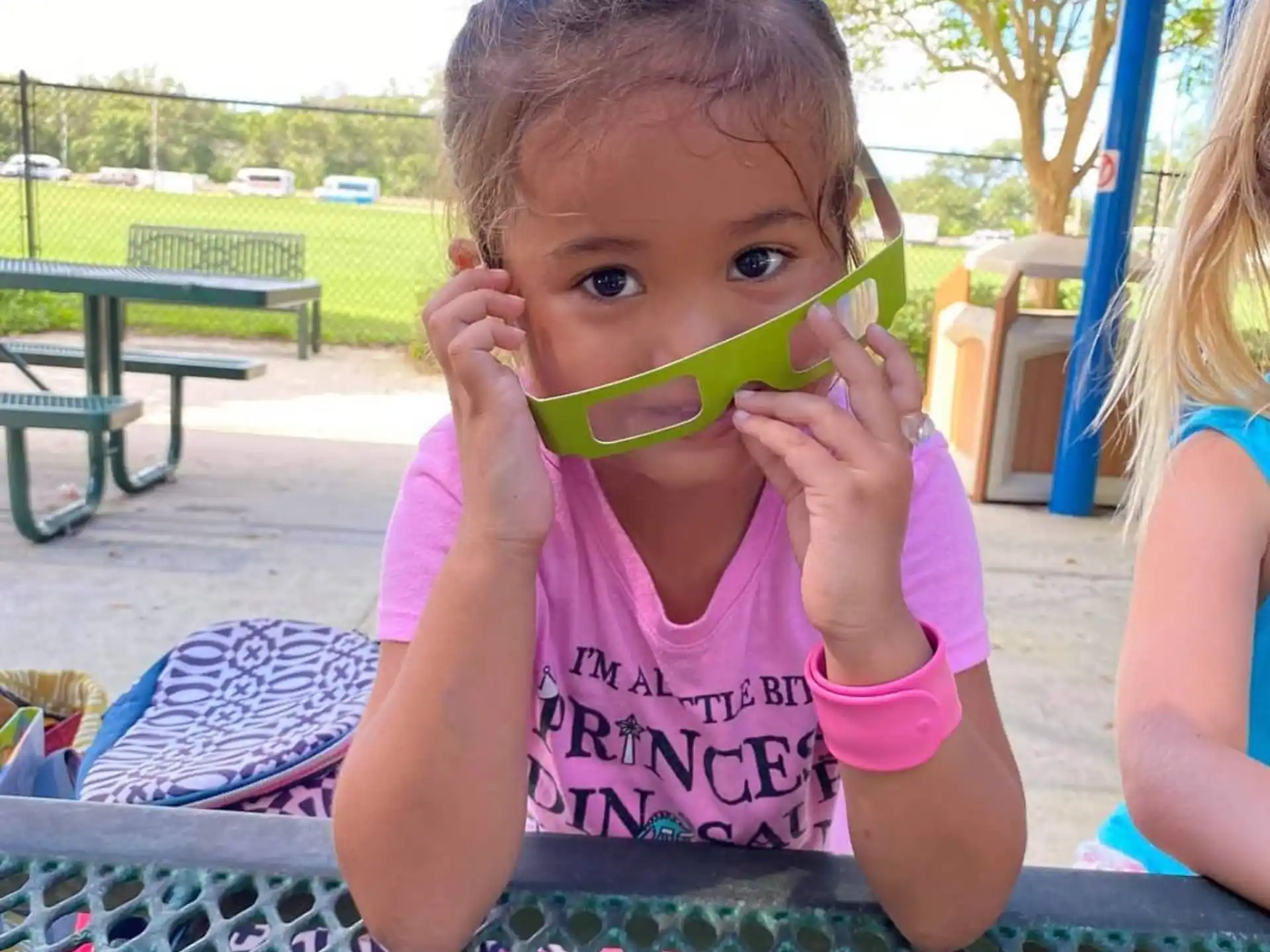 a baby drinking from a green cup