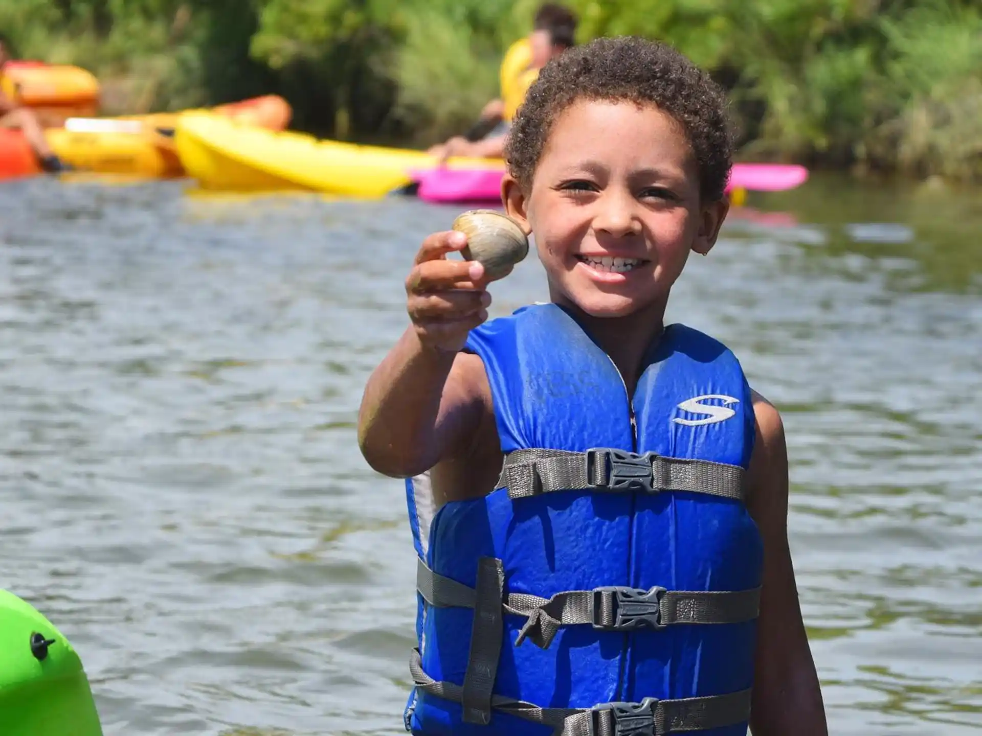 a boy holding a fish