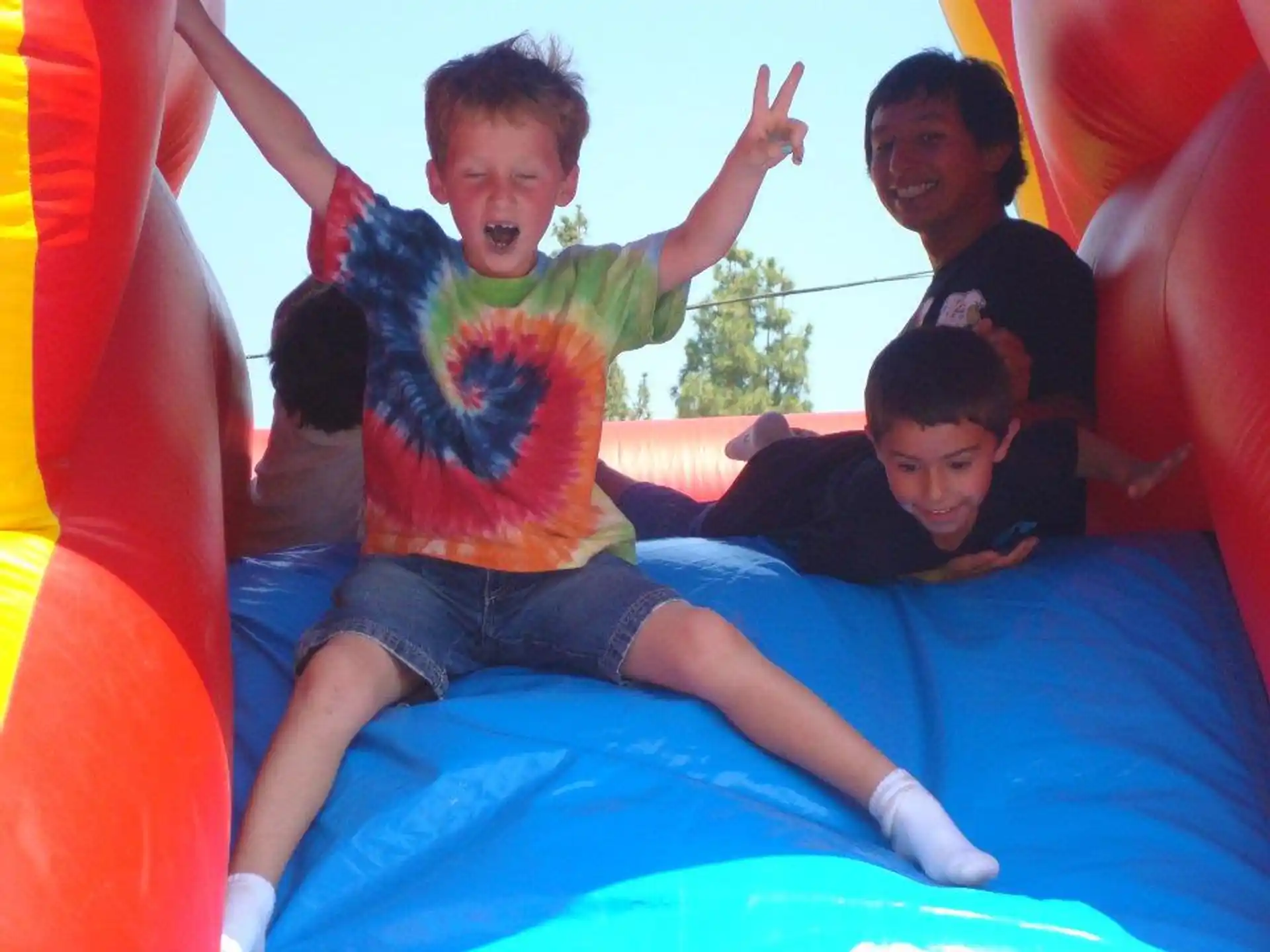 a group of people on a large blue and yellow slide