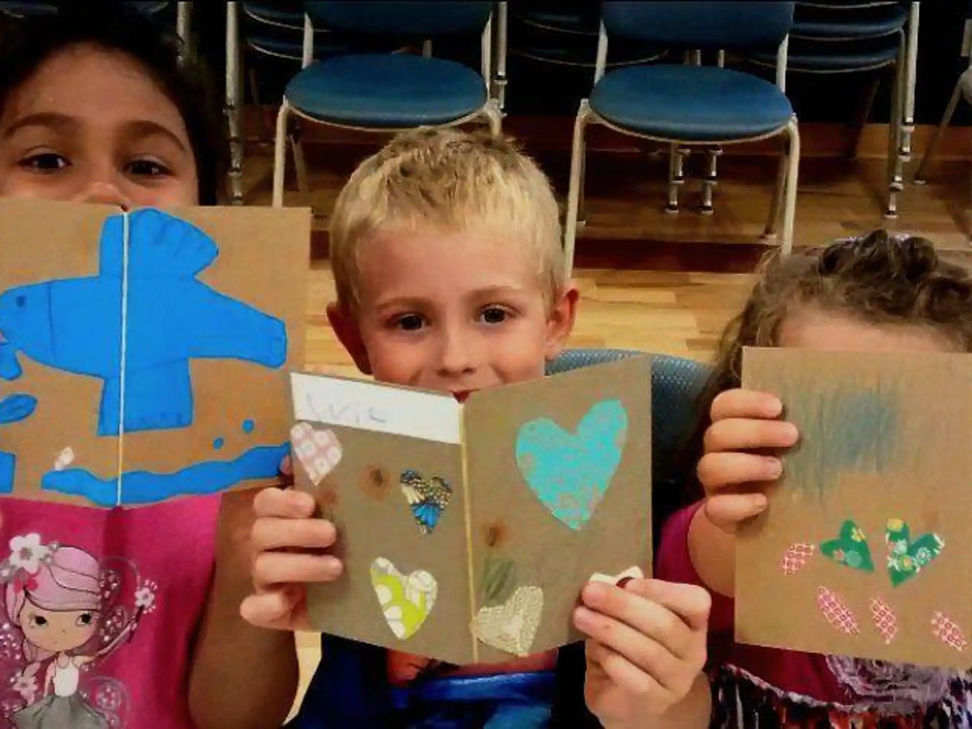 a couple of children holding books