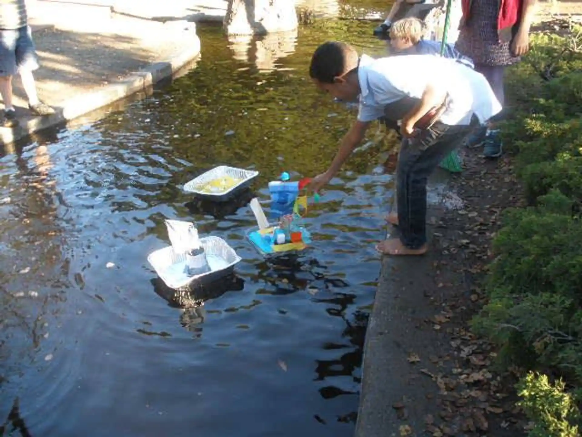 a man collecting water from a stream