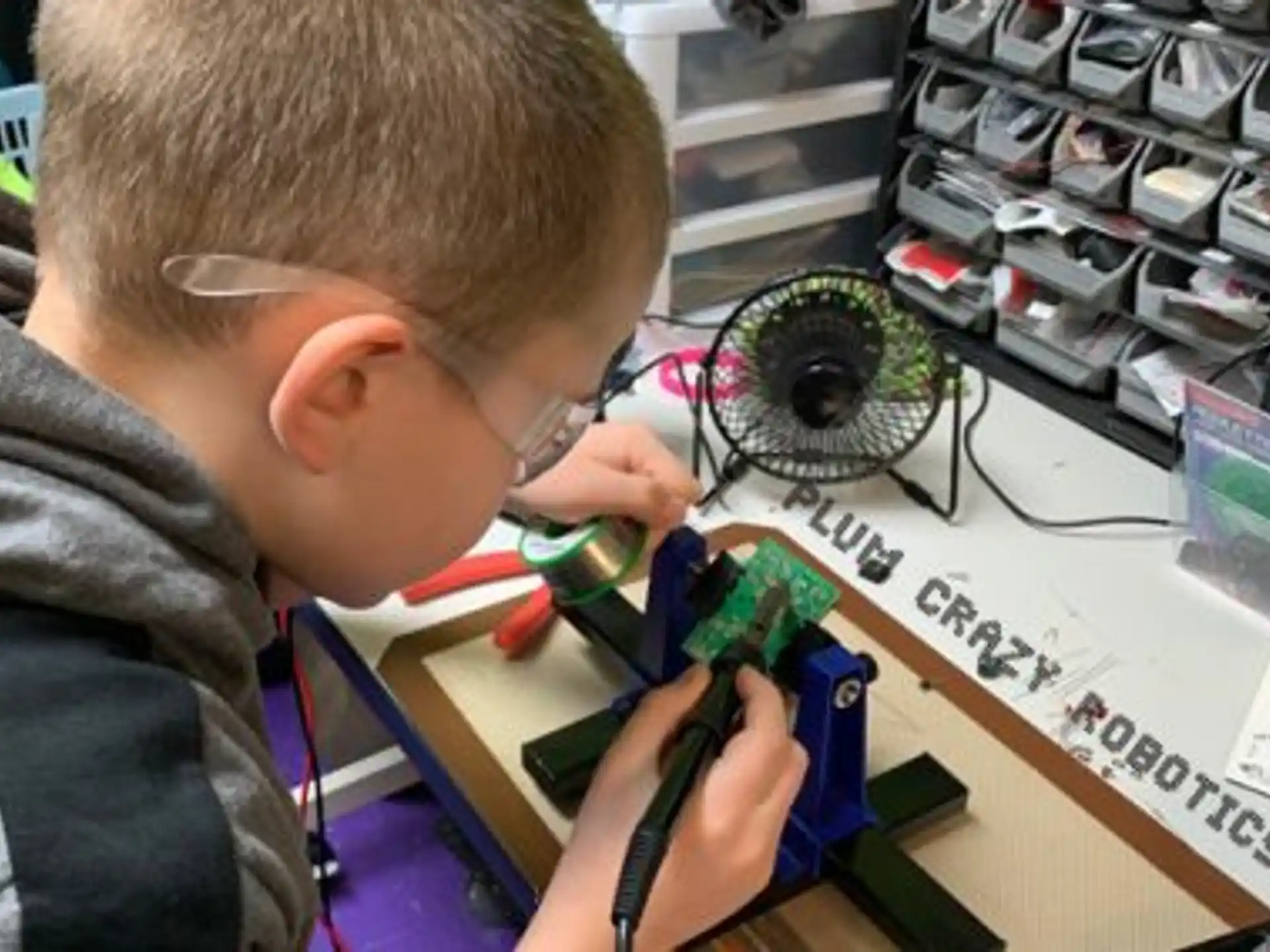 a boy using a microscope