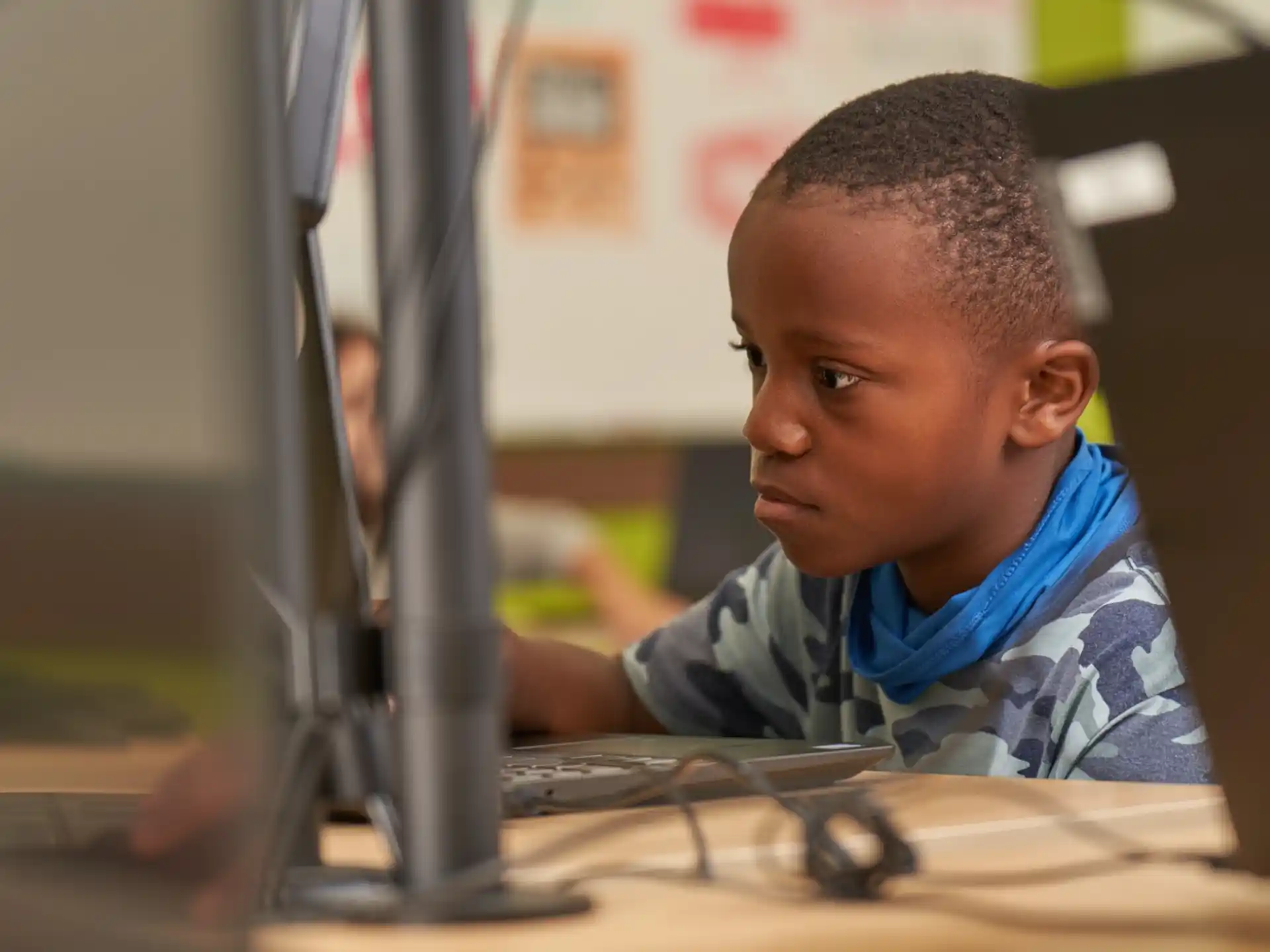 a young boy sitting at a desk