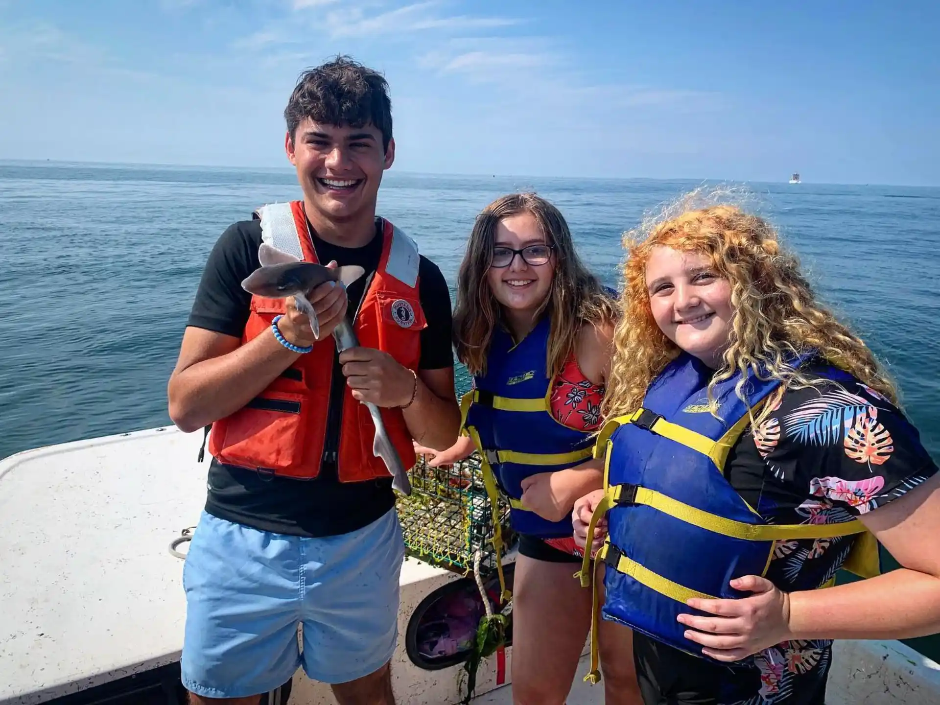 a group of people posing for a photo on a boat
