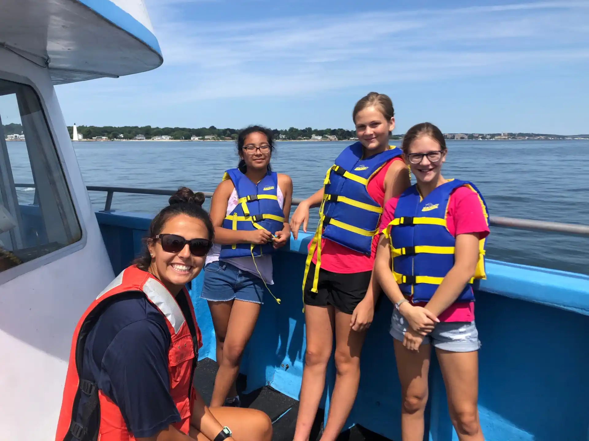 a group of people wearing life vests on a boat