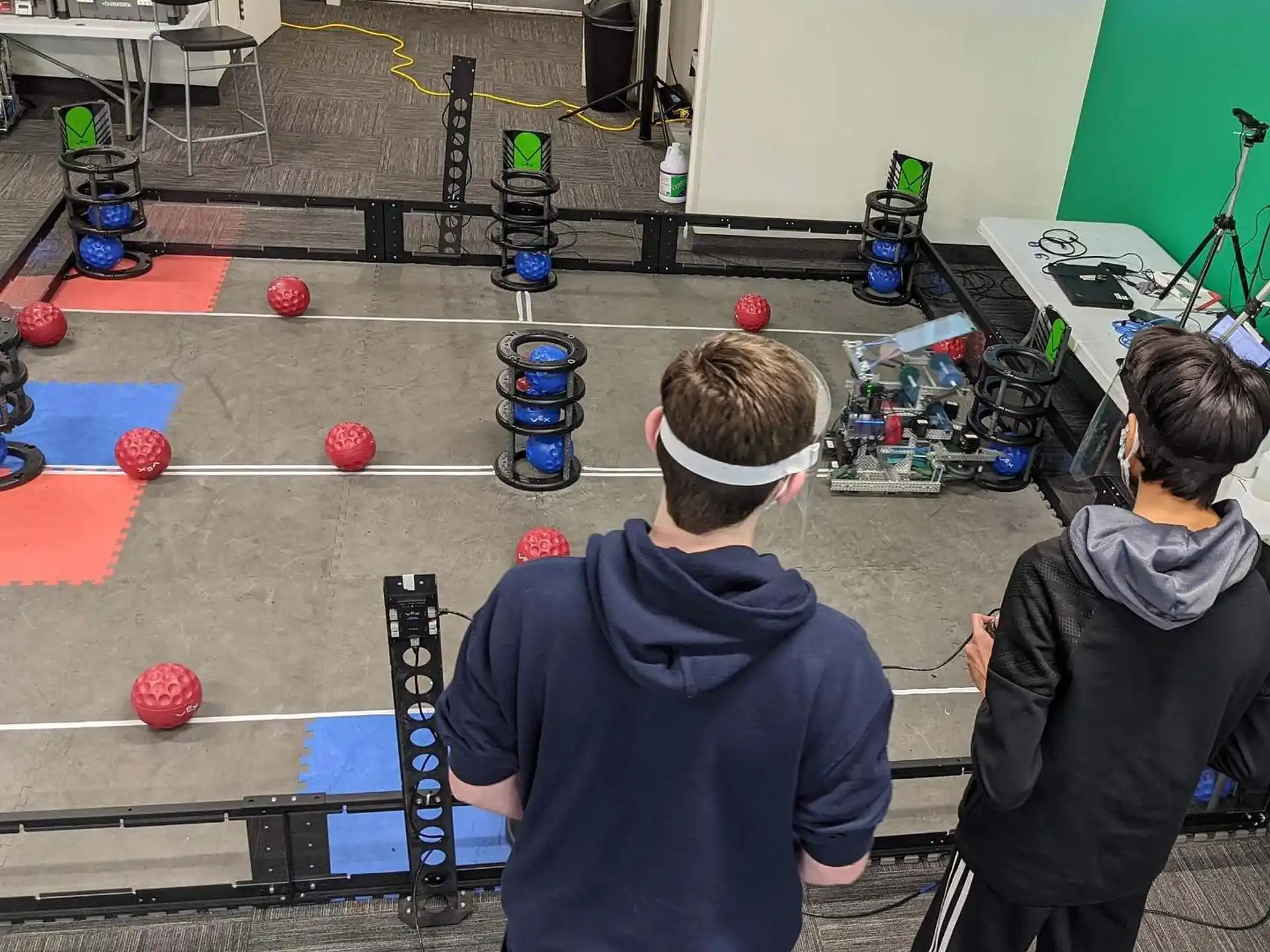 a couple of people in a room with balls on the floor