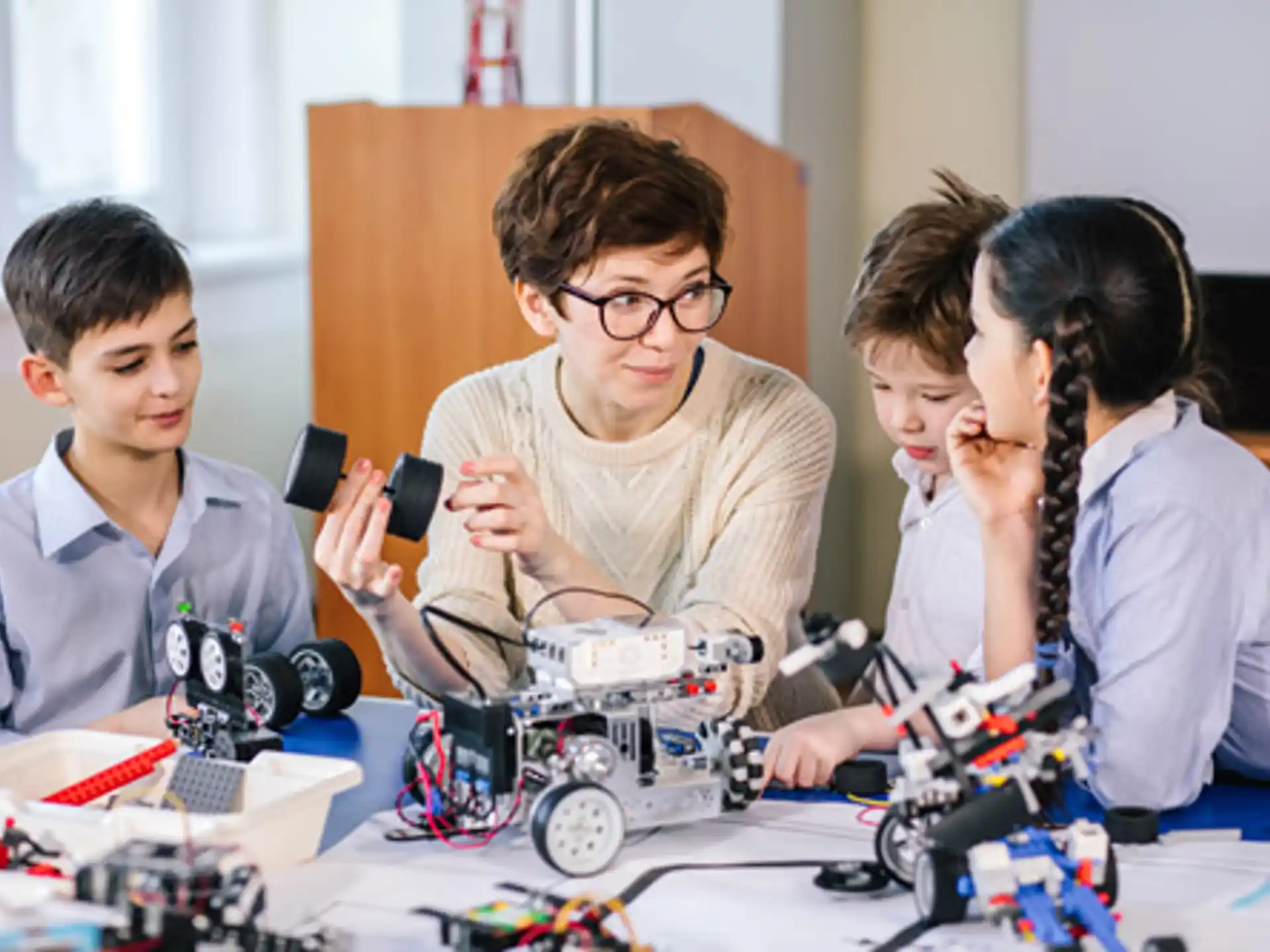 a group of people looking at a toy car