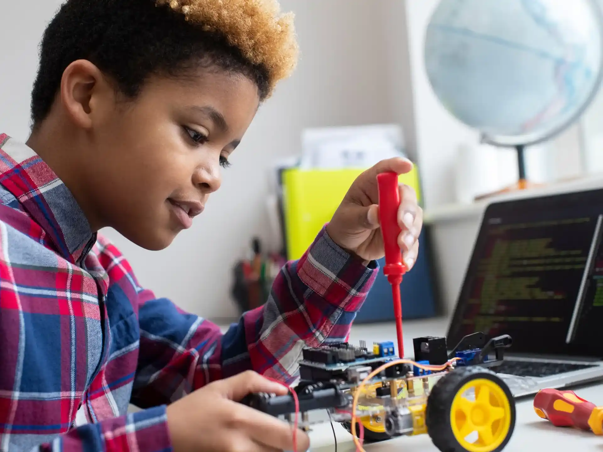 a young boy using a laptop