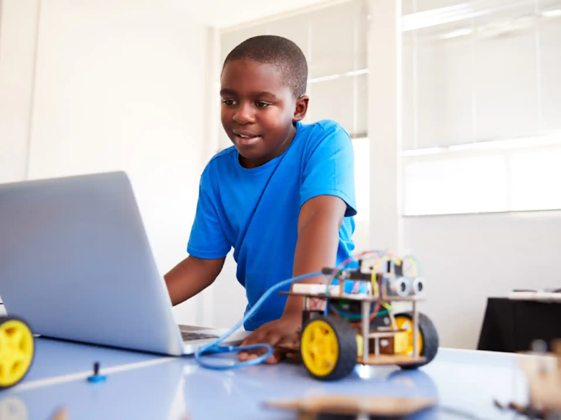 a young boy working on a laptop