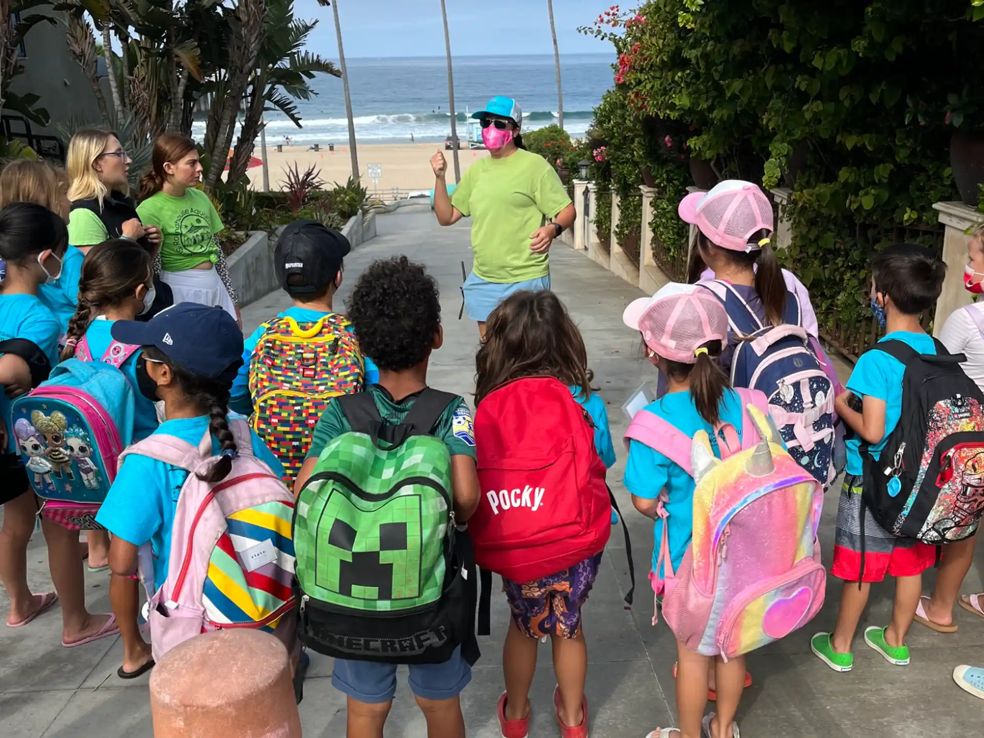 a group of children standing on a sidewalk