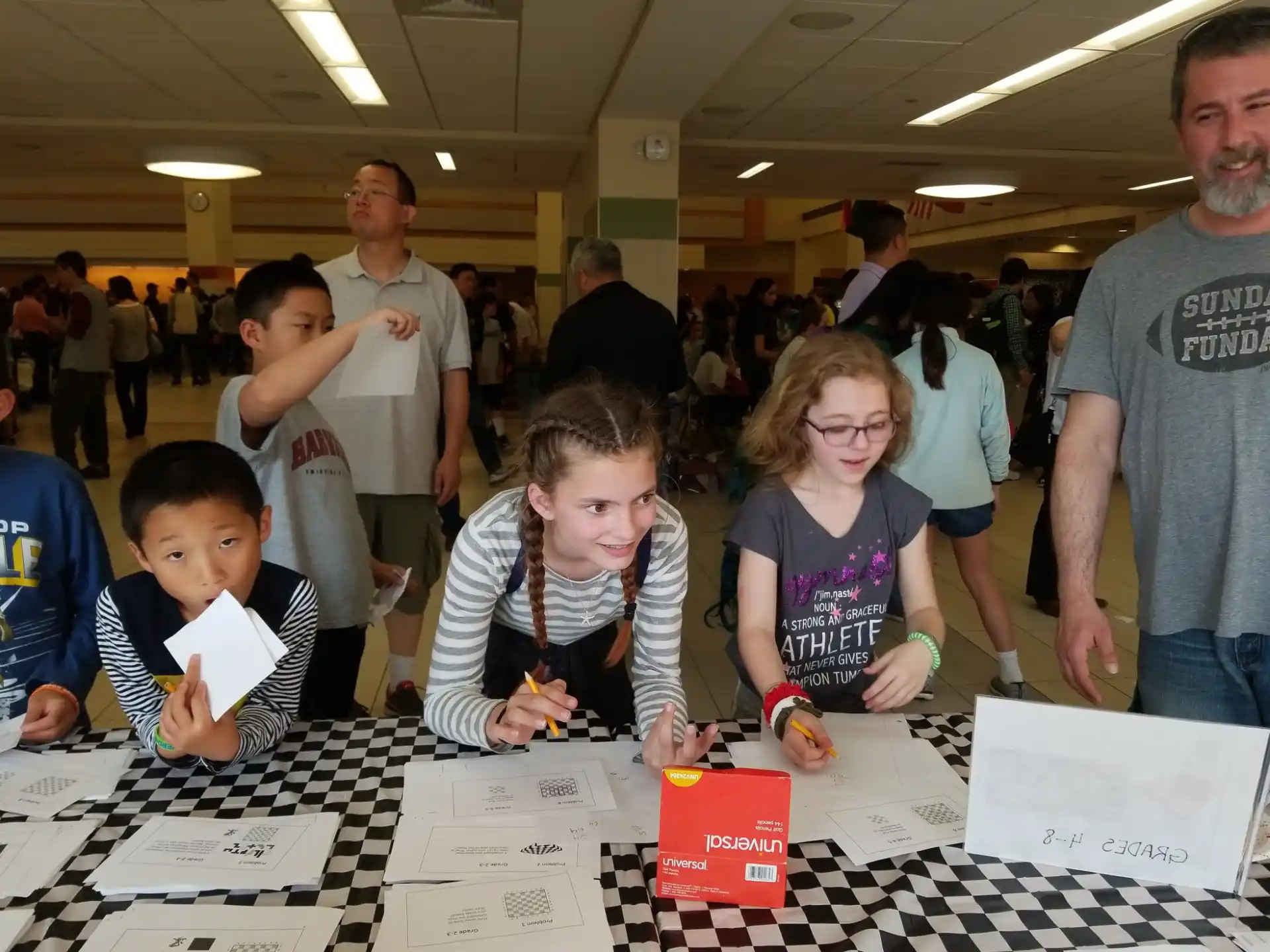 a group of people looking at papers