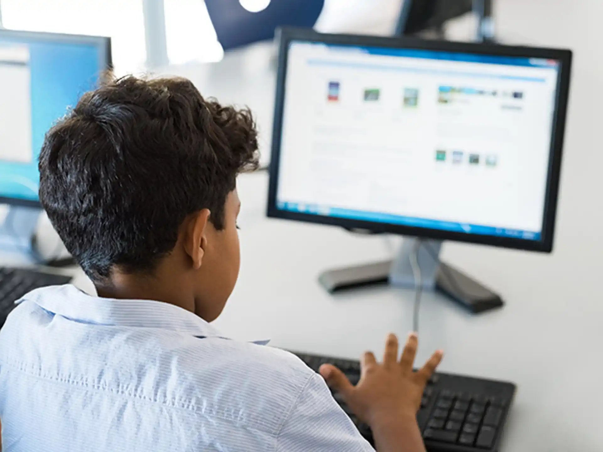 a man sitting in front of a computer