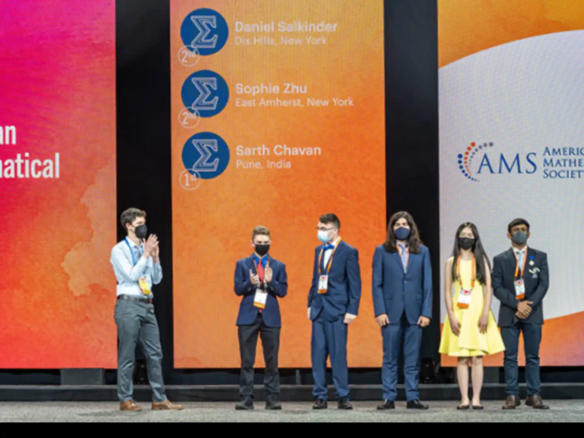 a group of people standing on a stage with microphones