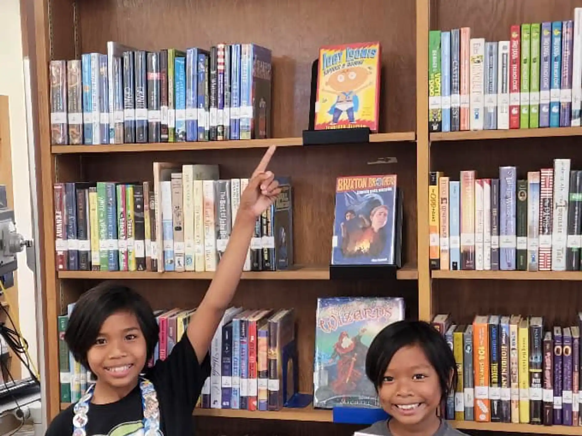a couple of kids holding books