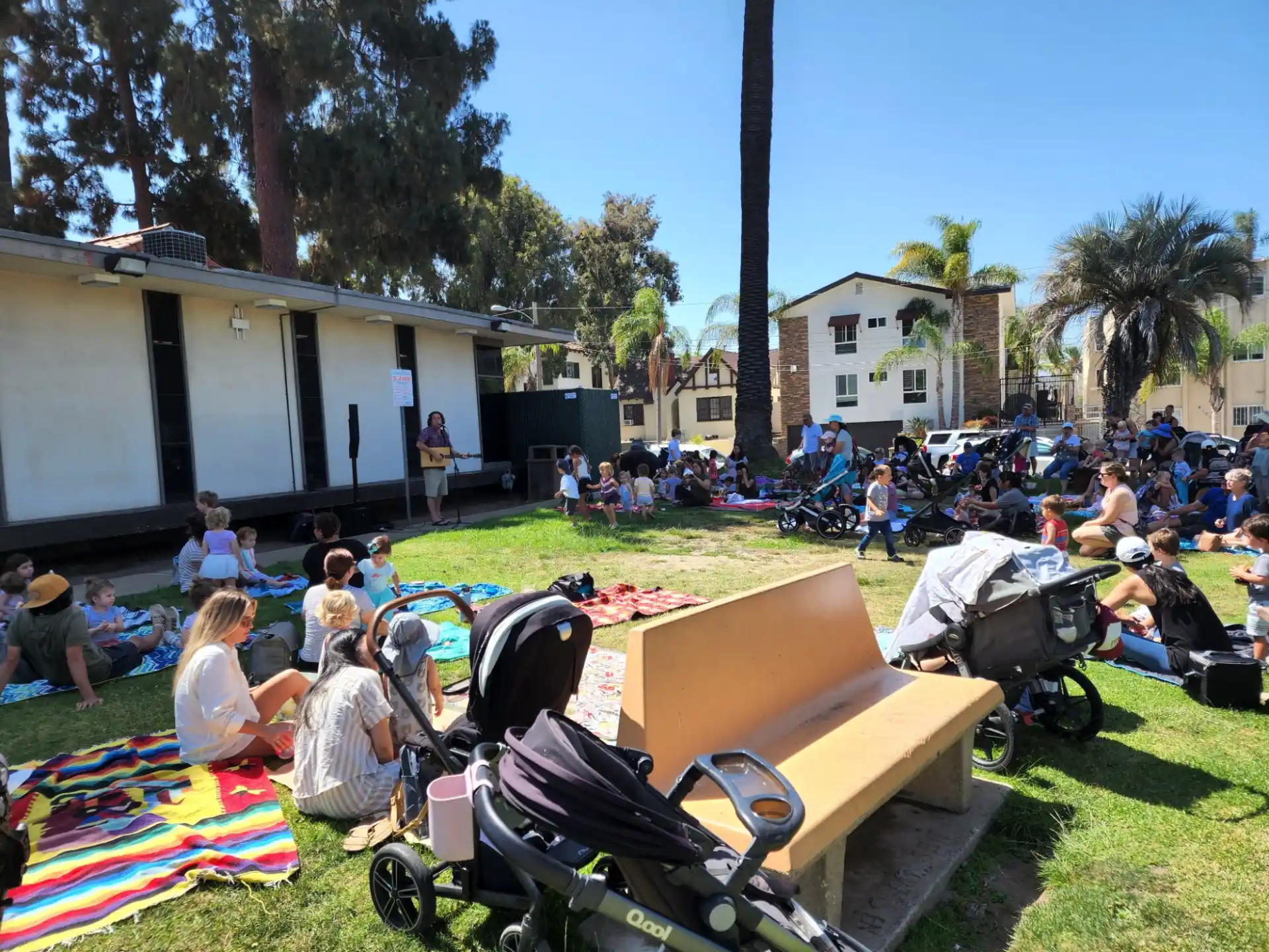 a group of people sitting on the grass
