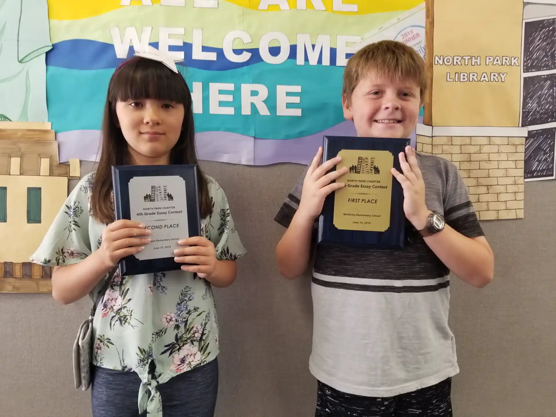 a couple of kids holding up books