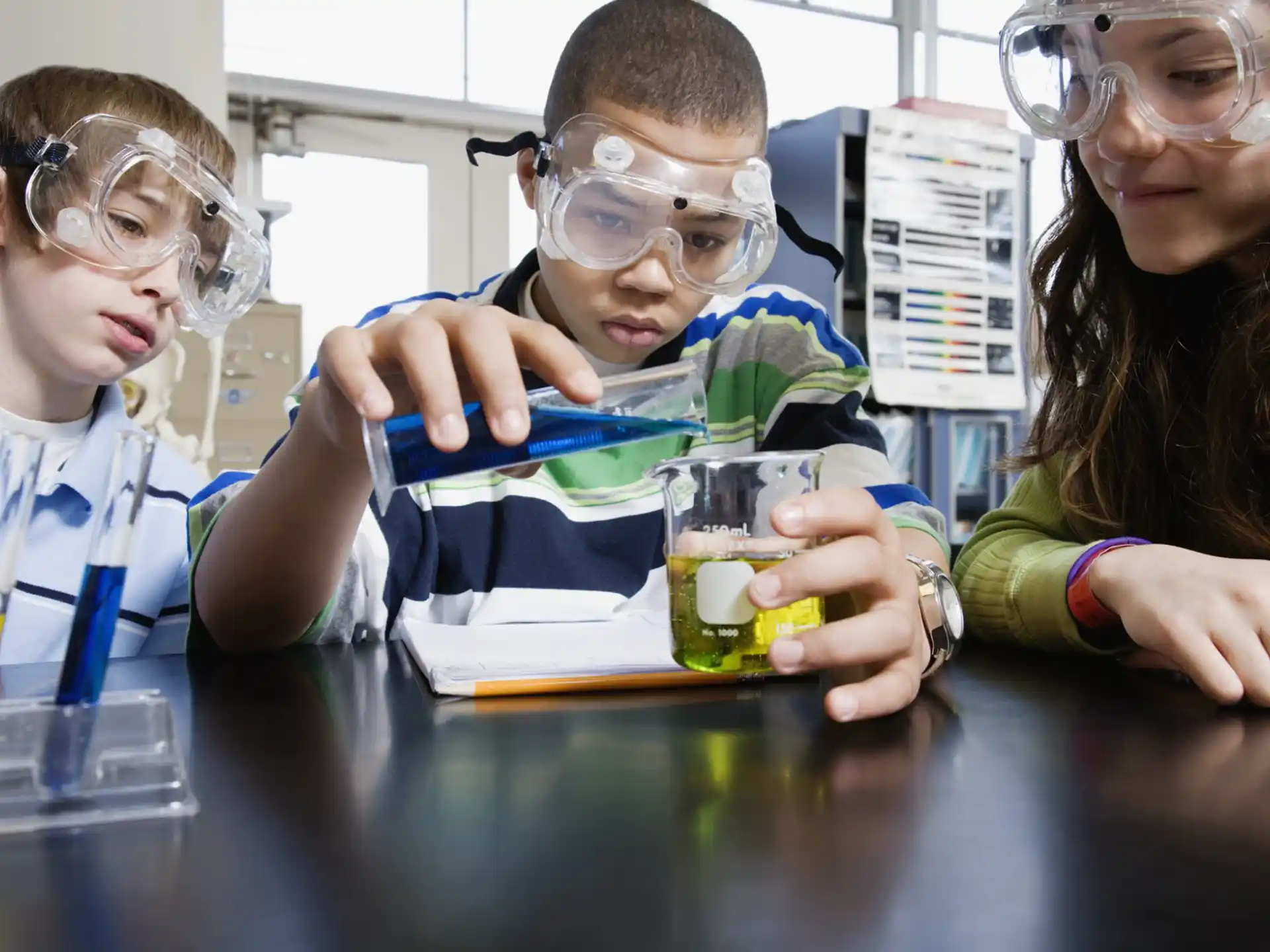 a group of people wearing safety goggles and holding cups