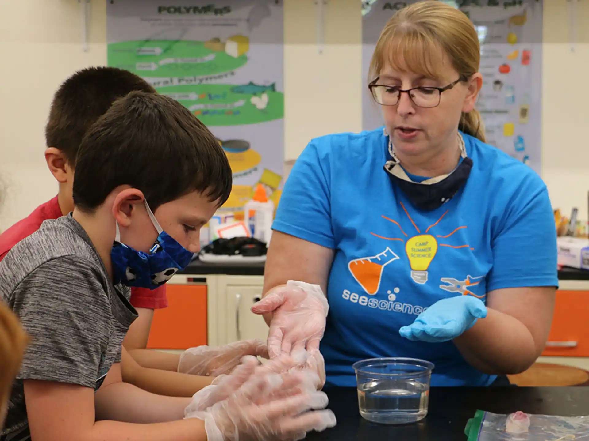 a person and a boy wearing safety goggles and a mask