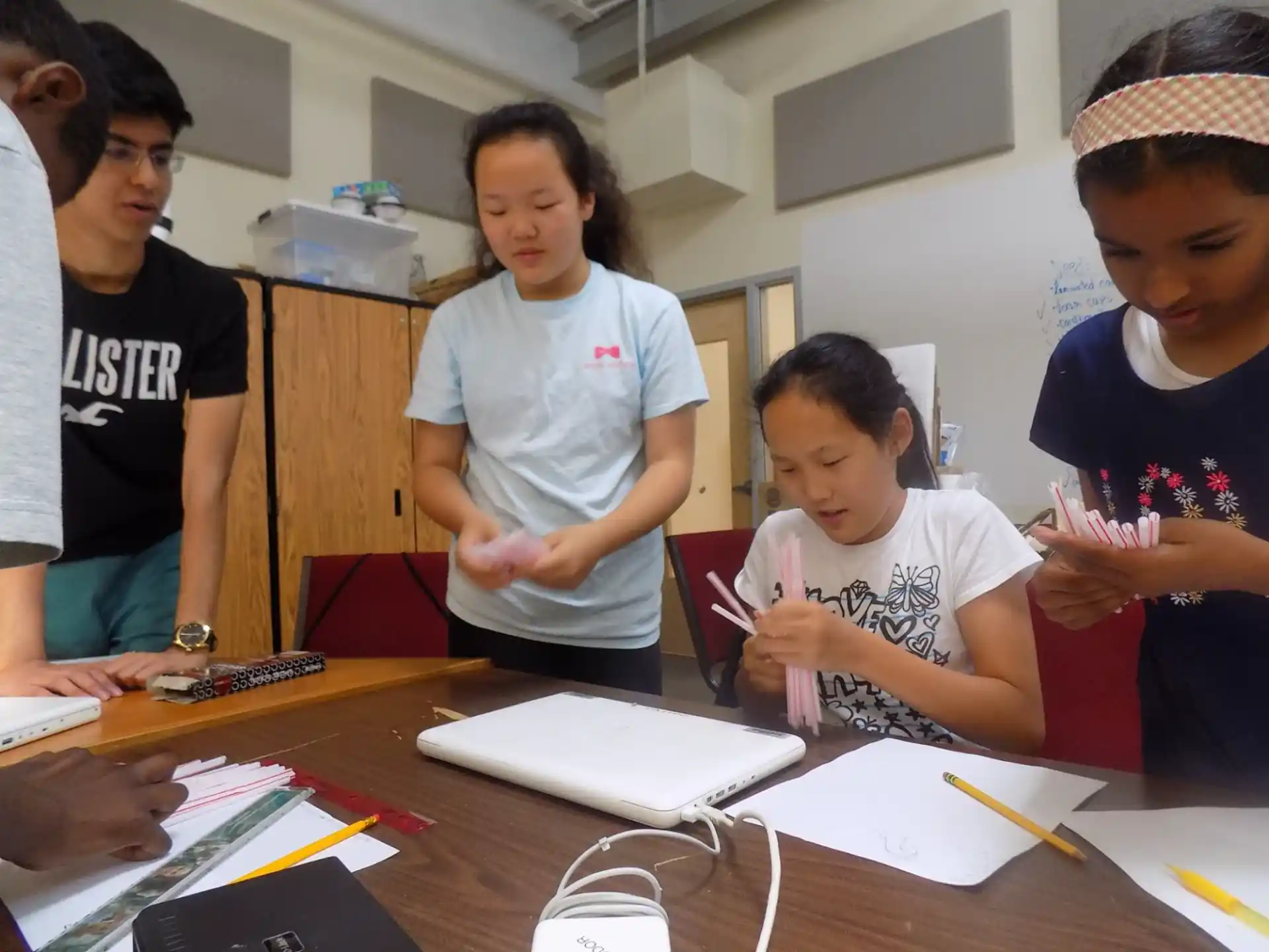 a group of people standing around a table with papers on it