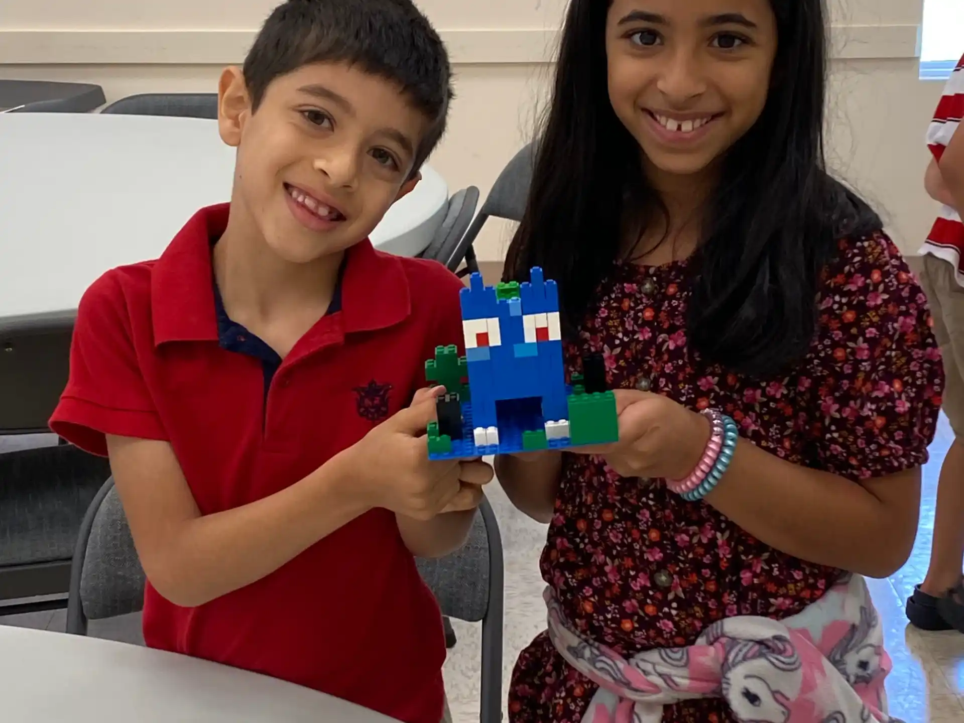a boy and girl holding a box