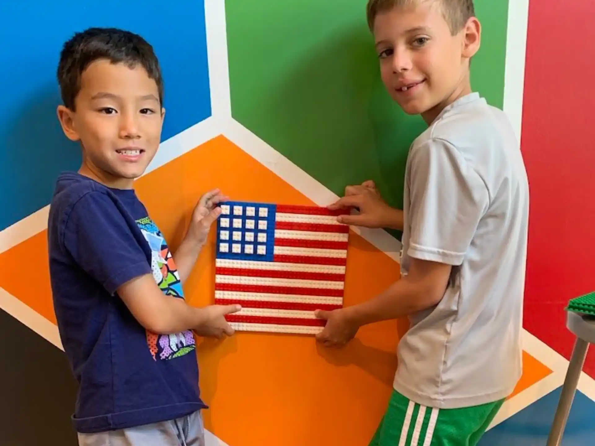 a couple of boys holding a flag