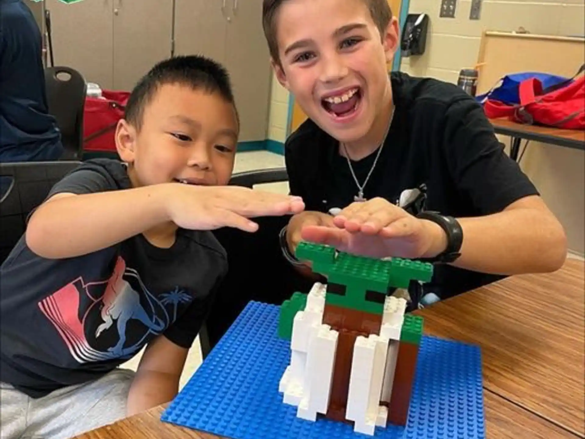 a boy and a boy with a toy train on a table