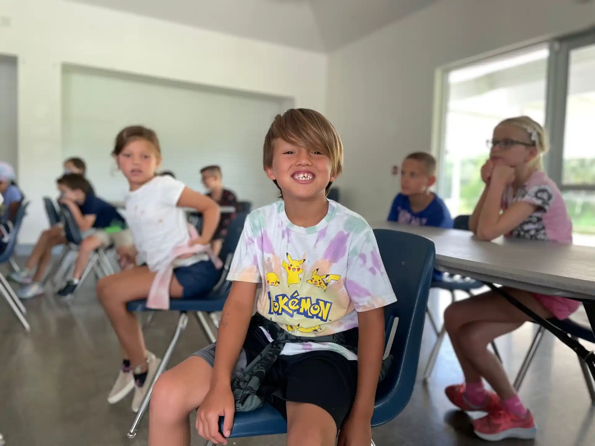 a group of children sitting in chairs