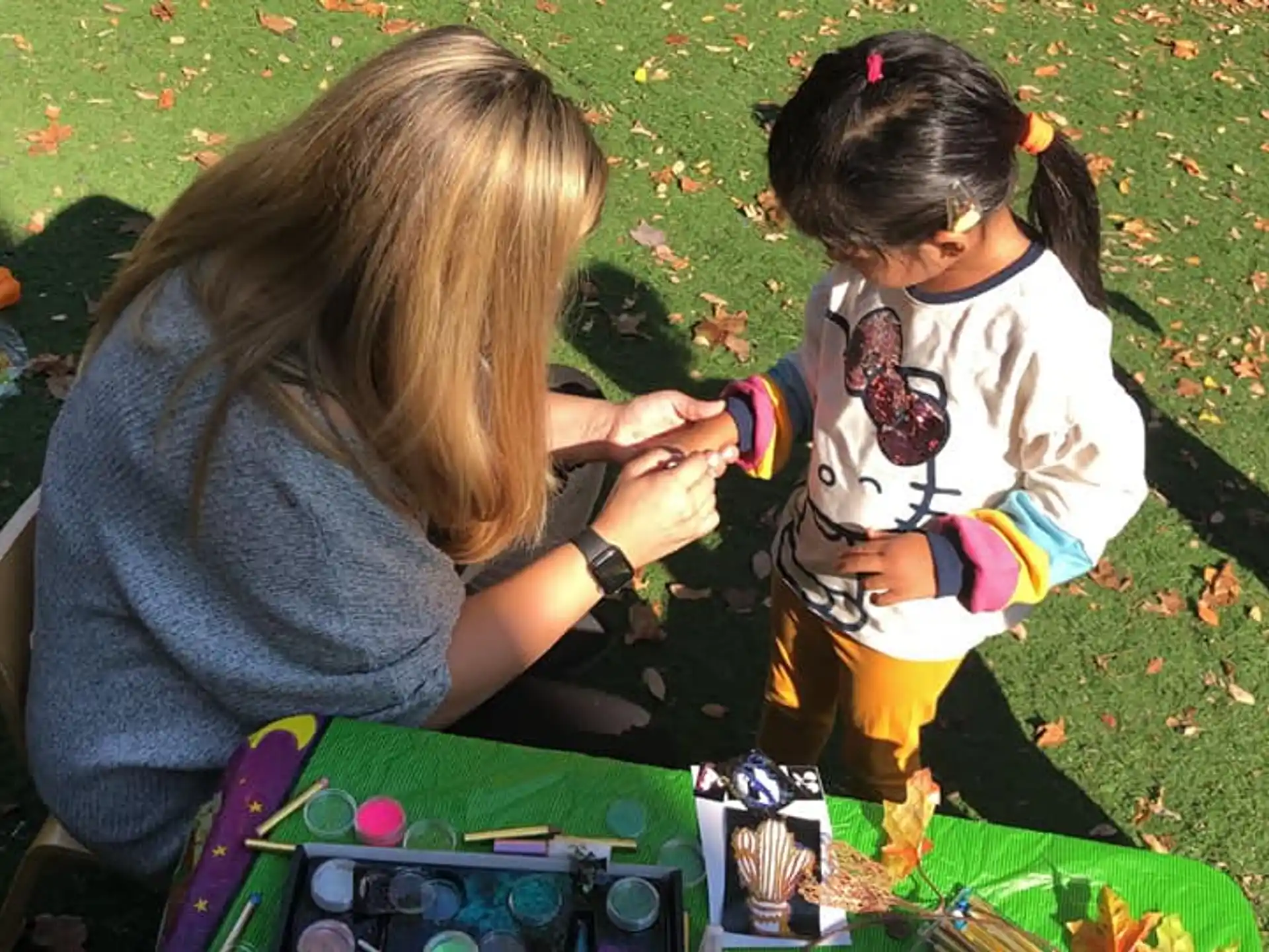 a couple of young girls playing with a toy