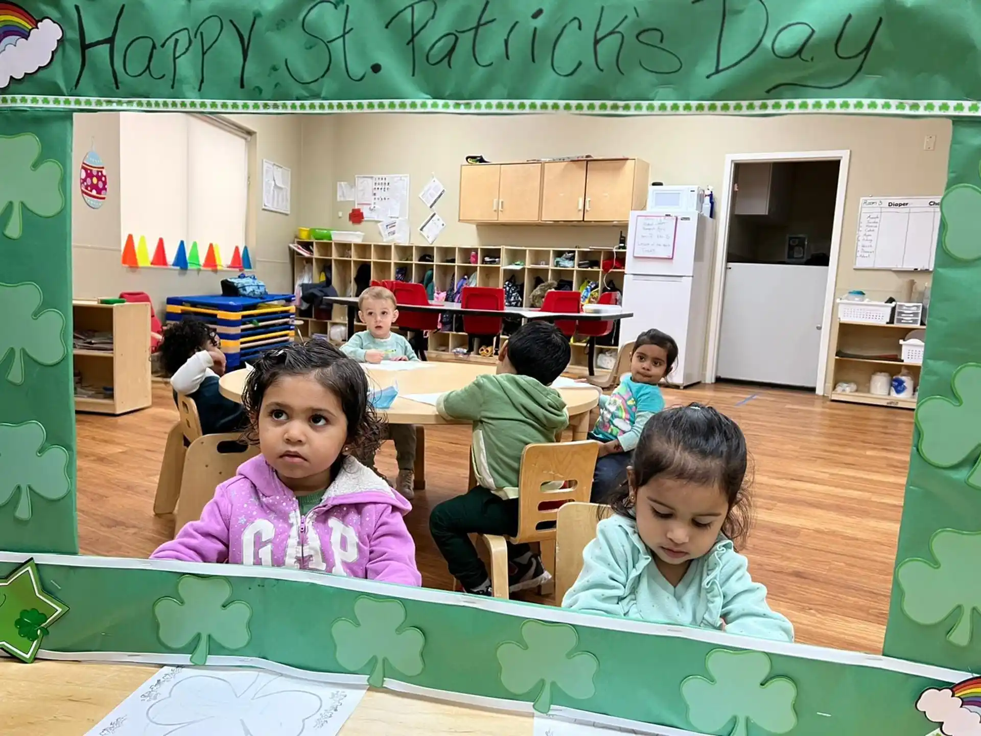 a group of children sitting at desks in a classroom