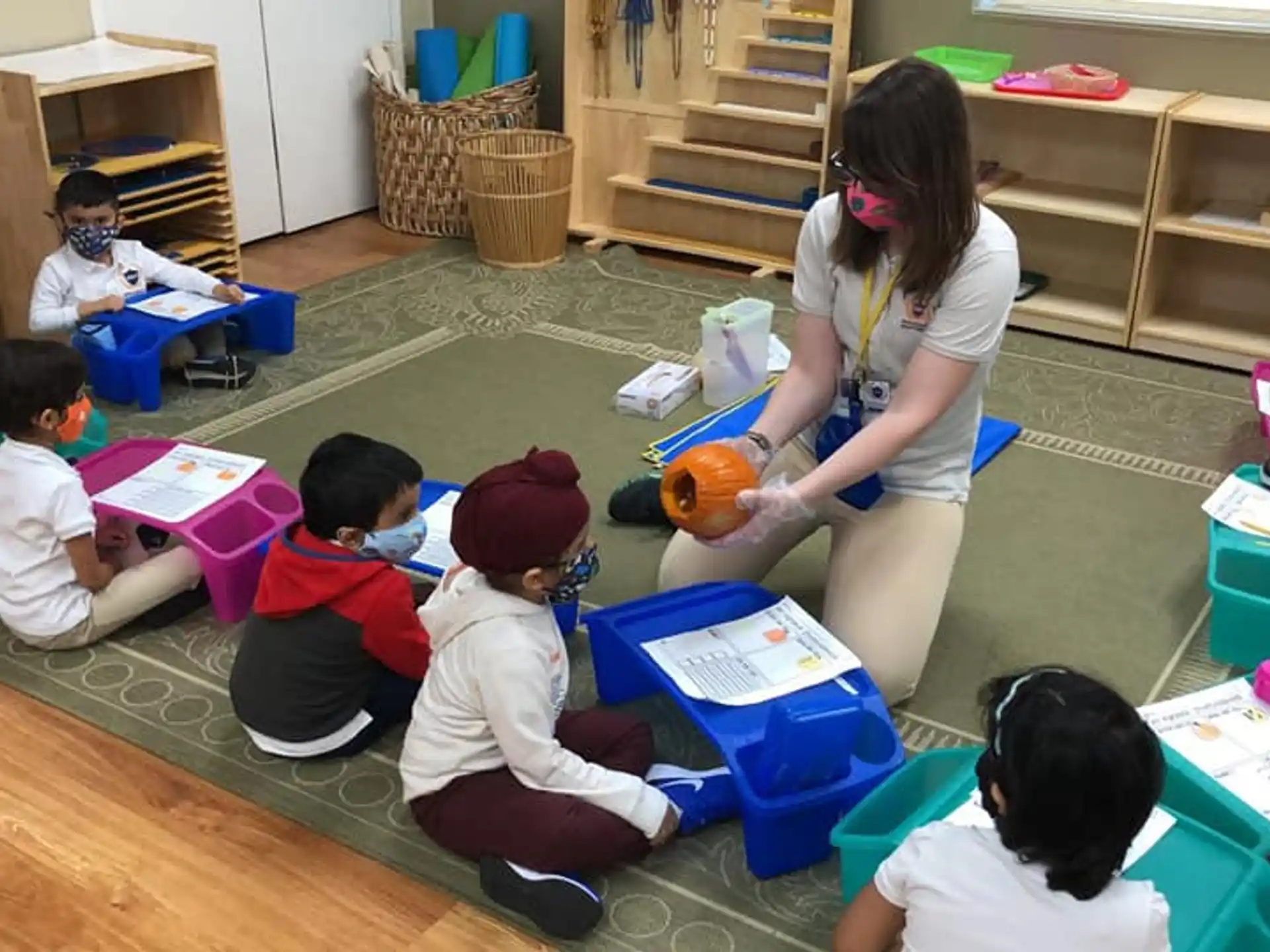 a person and several children sitting on the floor