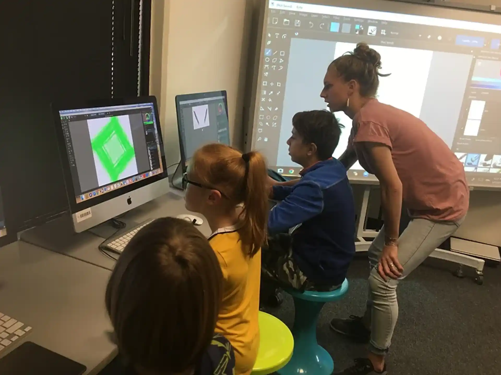 a group of people looking at a computer screen