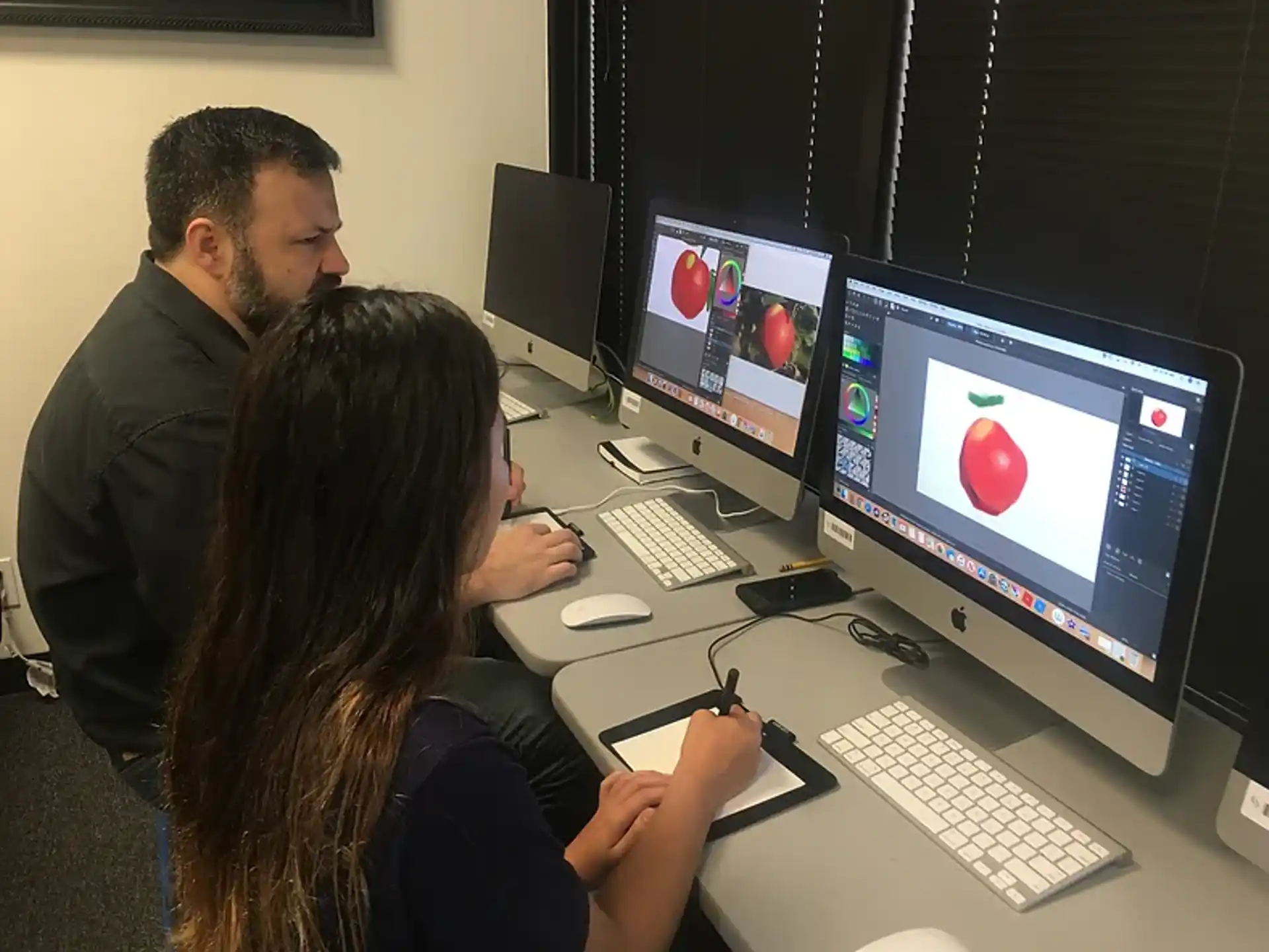 a man and a woman working on computers