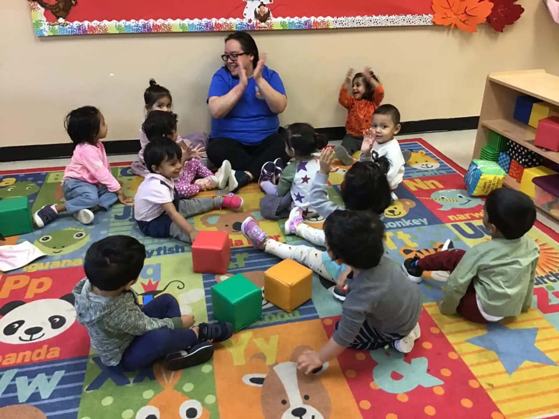 a person and several children playing with toys on the floor