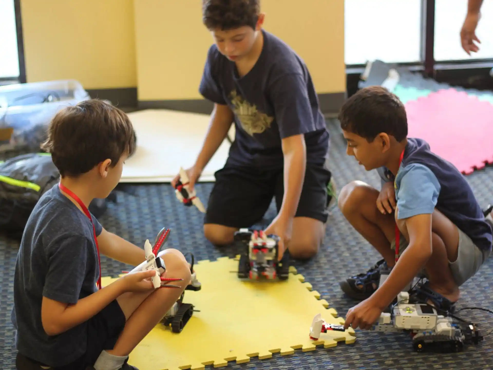 a group of boys playing with toy cars