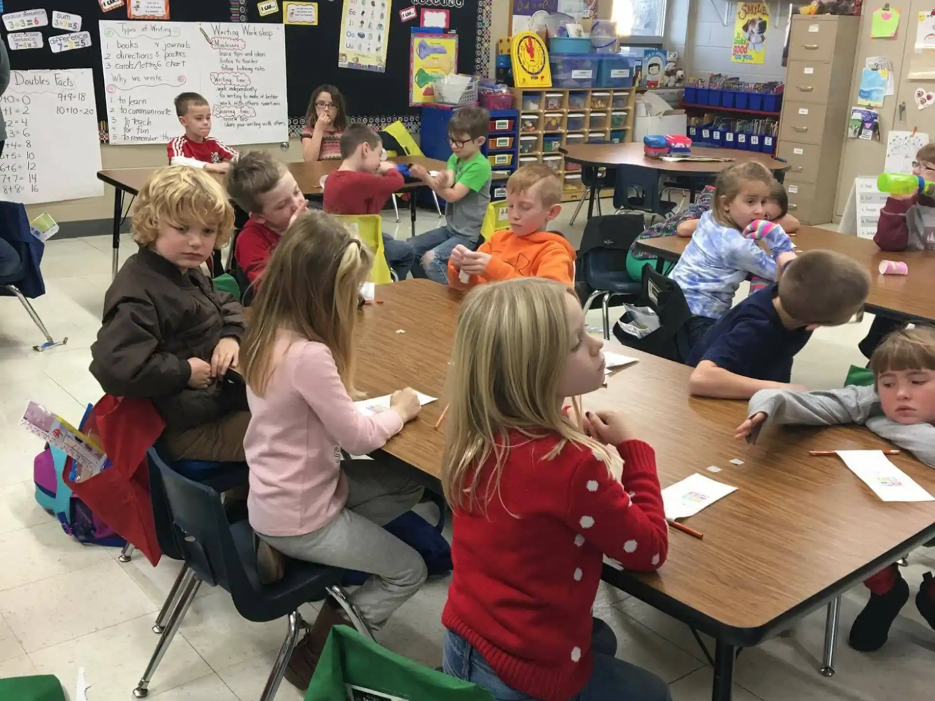 a group of children sitting at desks in a classroom