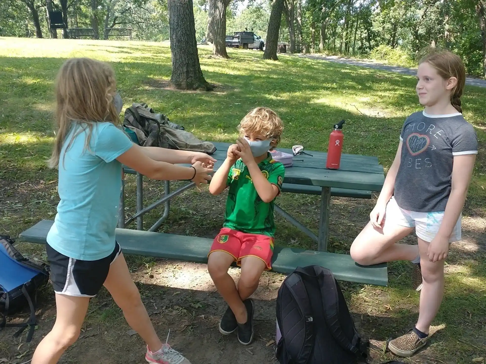a group of kids playing with a toy gun