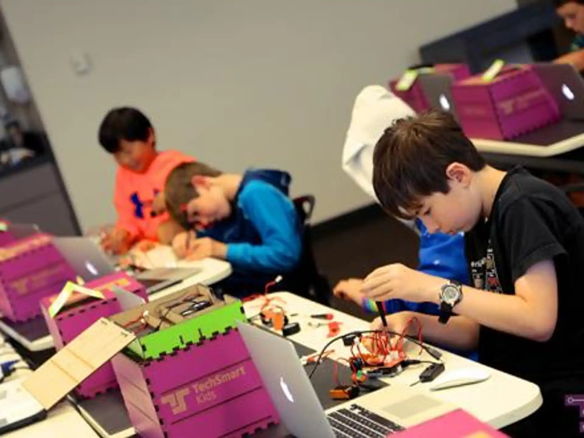a group of people working on a laptop