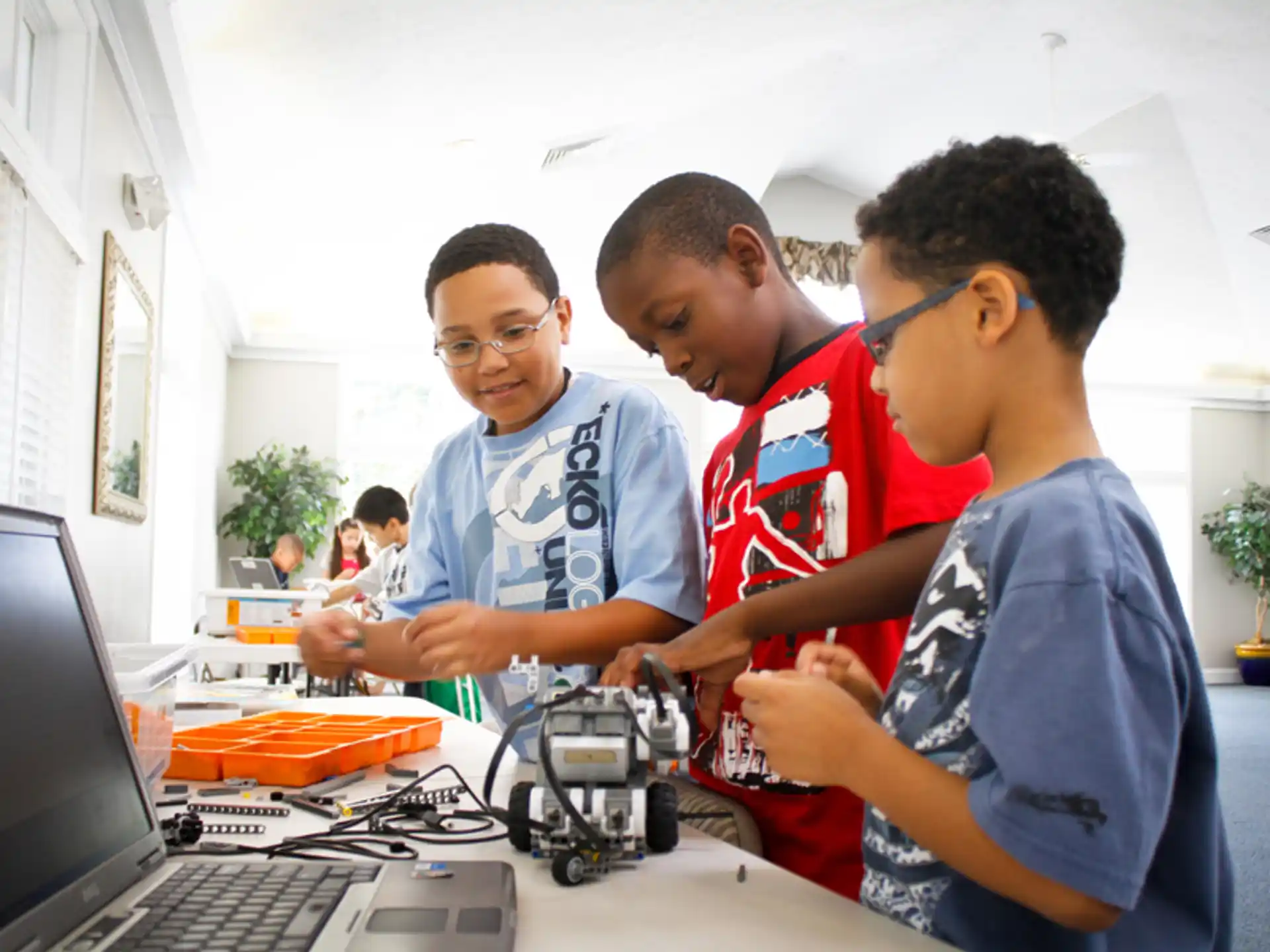 a group of young men looking at a laptop