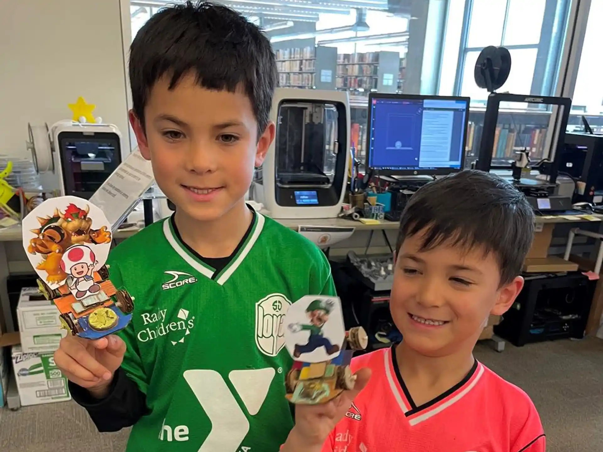 a couple of boys holding a toy