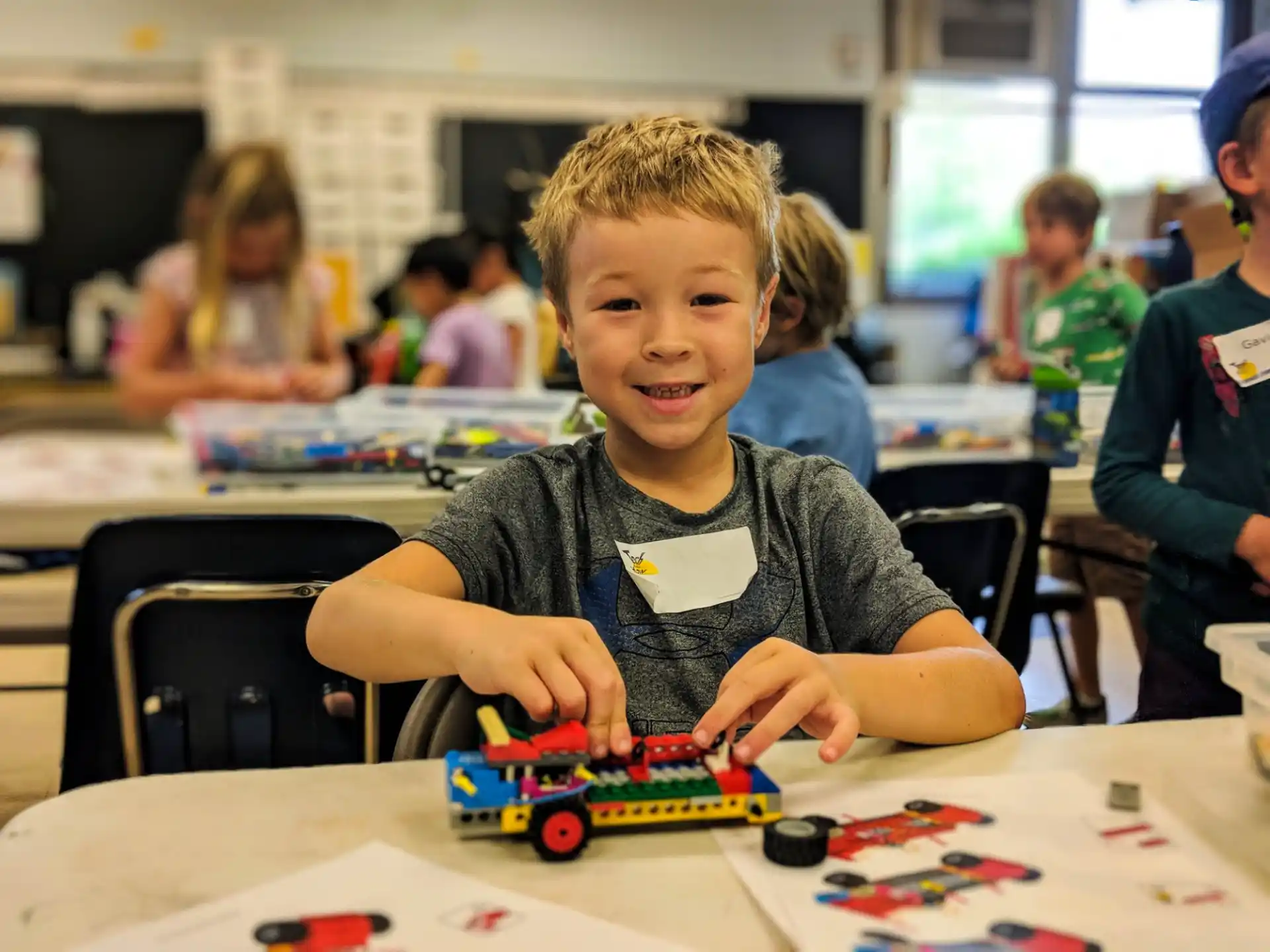 a young boy playing with a toy train
