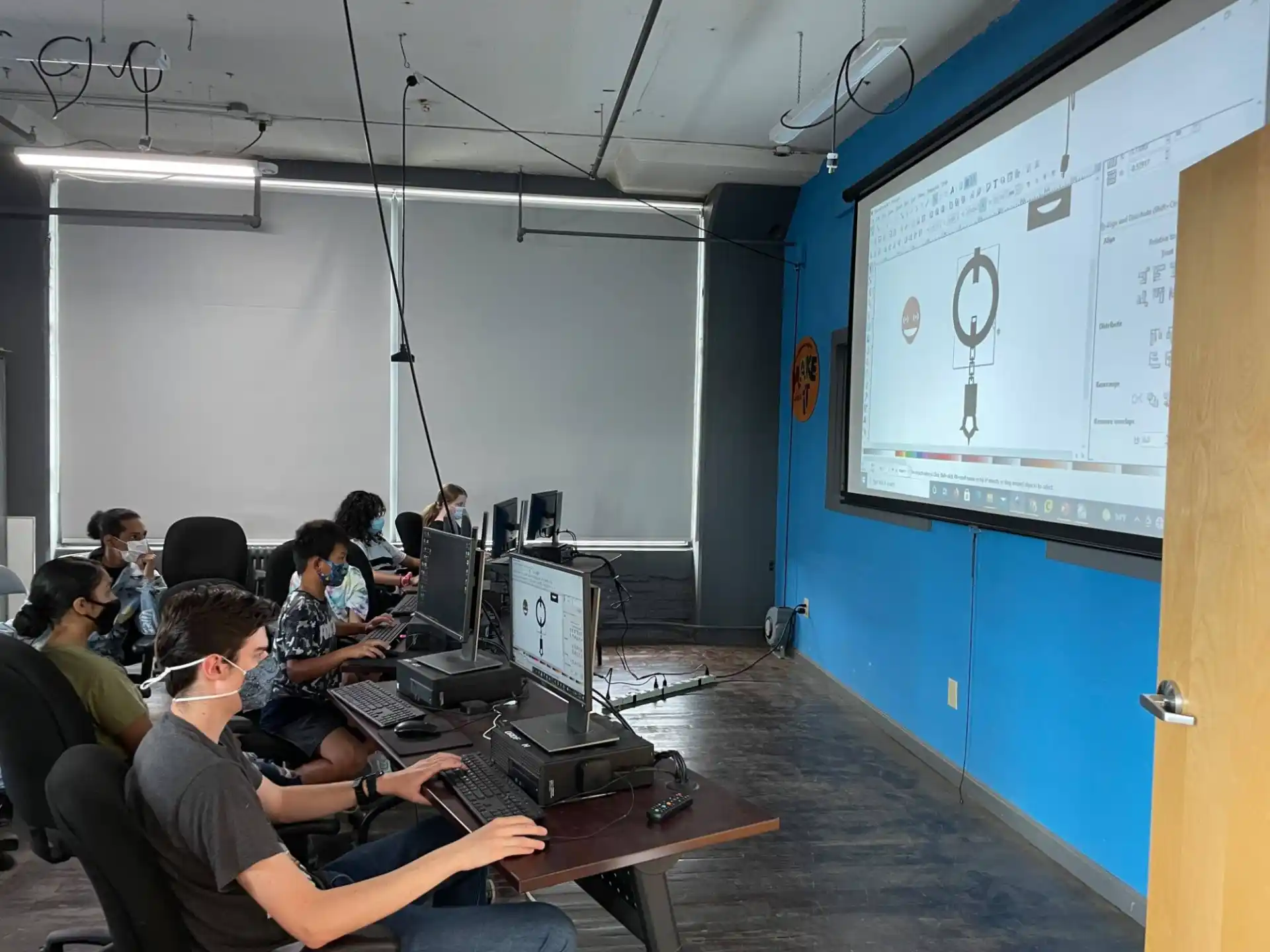a group of people sitting at computers