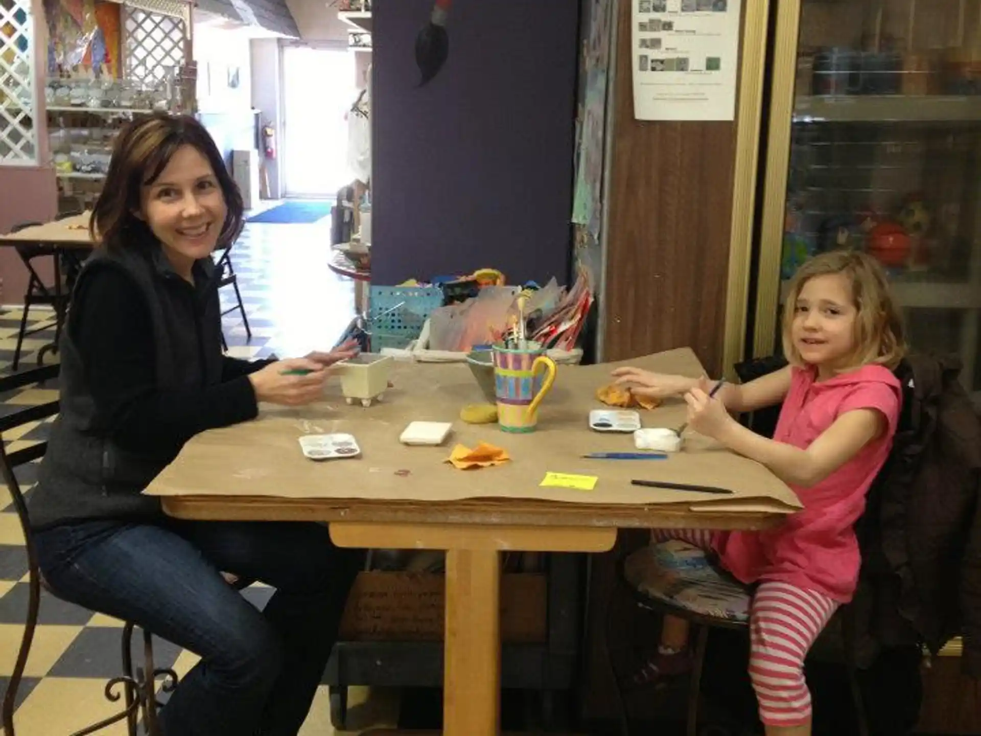 a woman and a girl sitting at a table