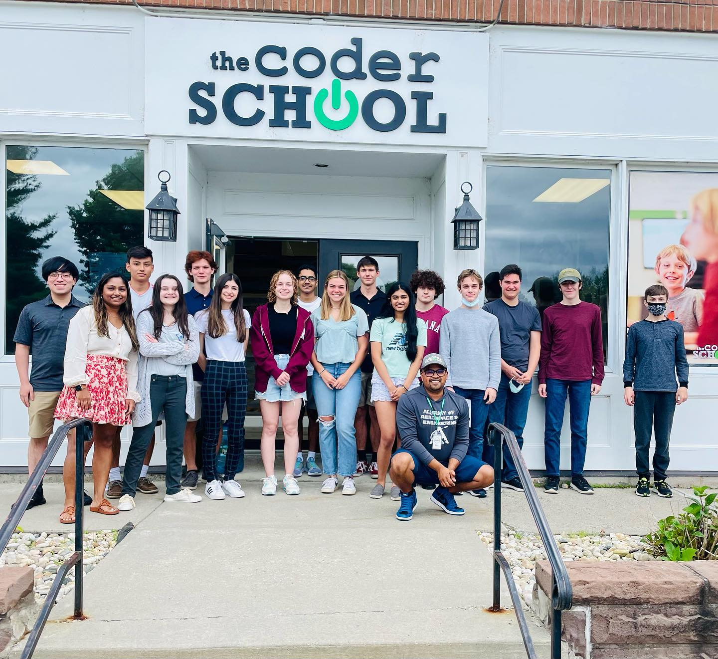a group of people posing for a photo outside a building