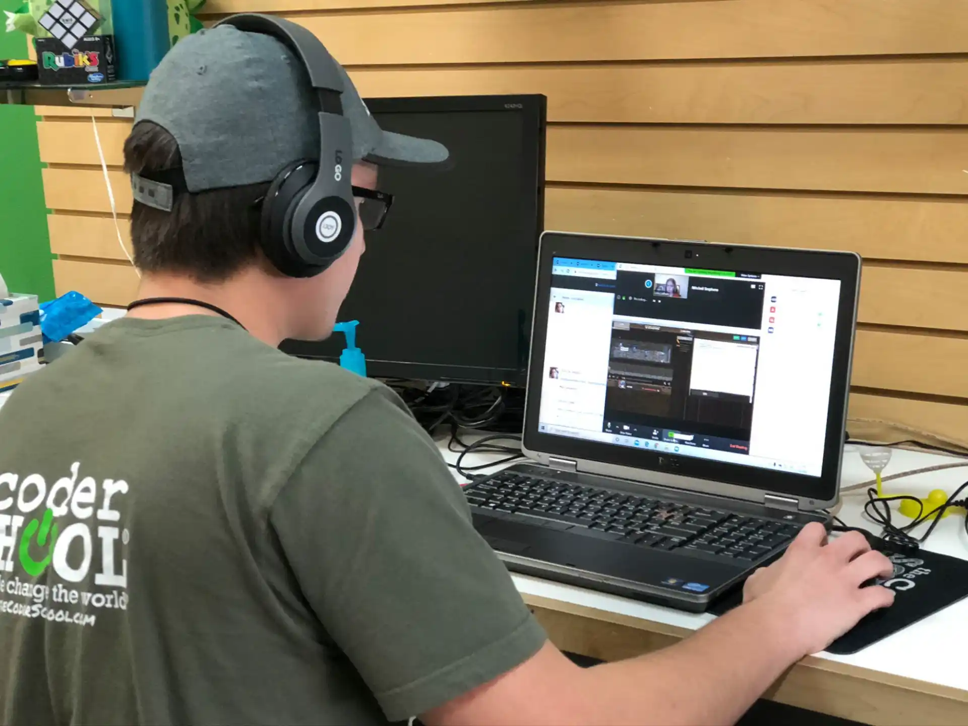 a man wearing headphones and using a laptop