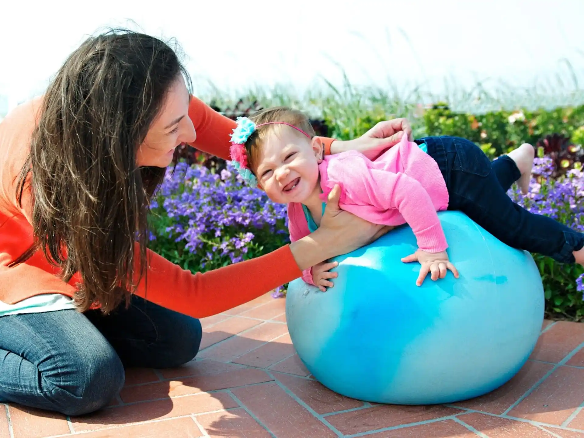 a woman and a baby playing in a ball pit