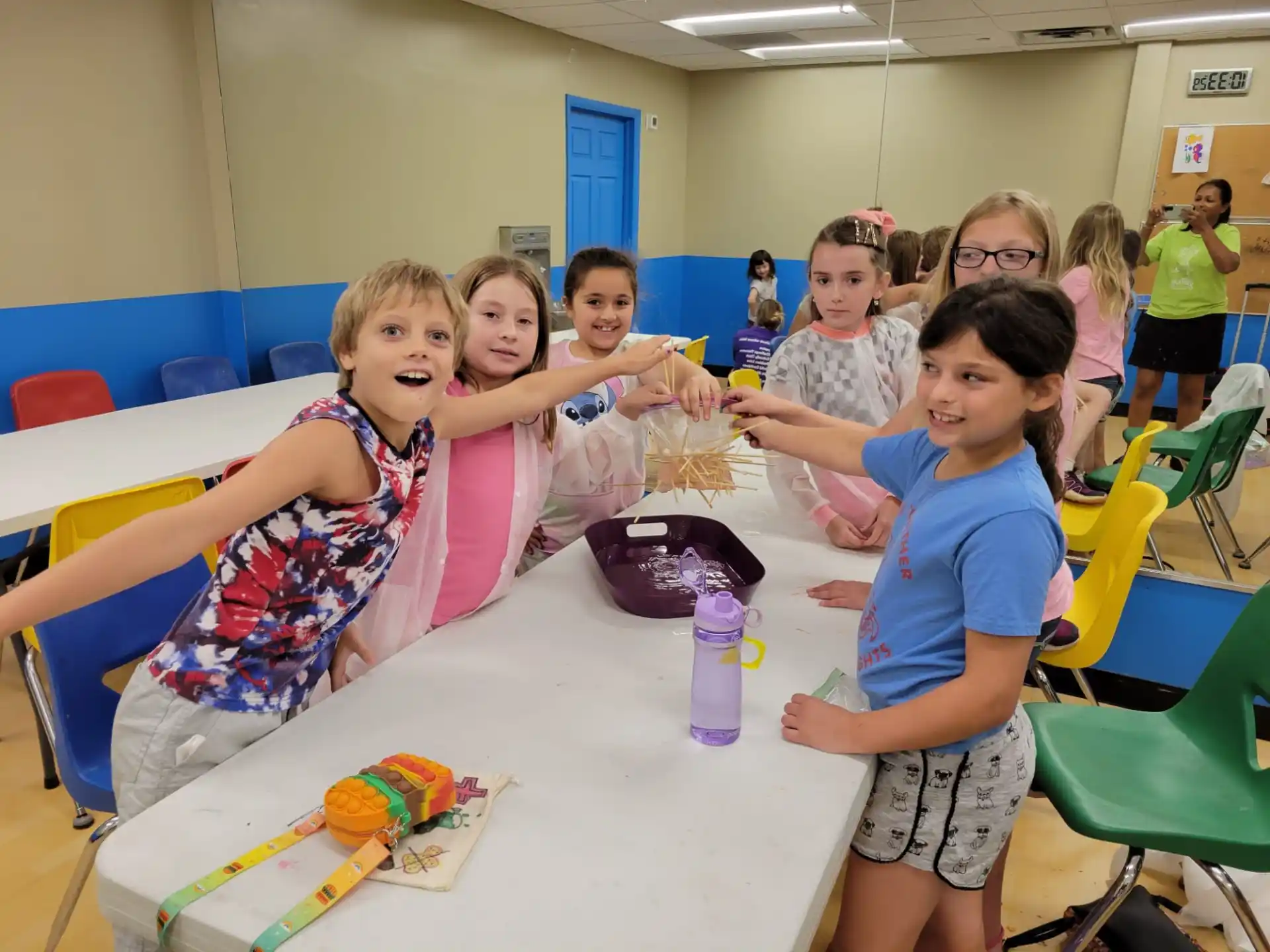 a group of children sitting at a table