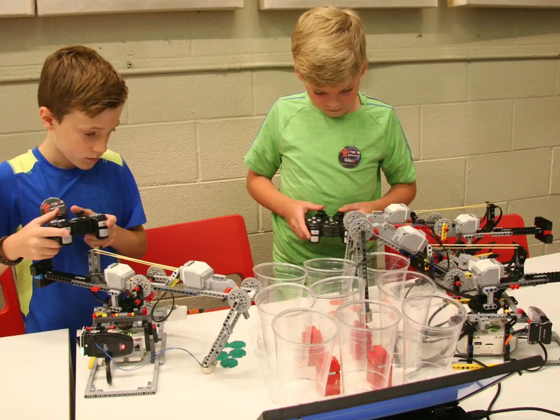 a couple of boys looking at a microscope