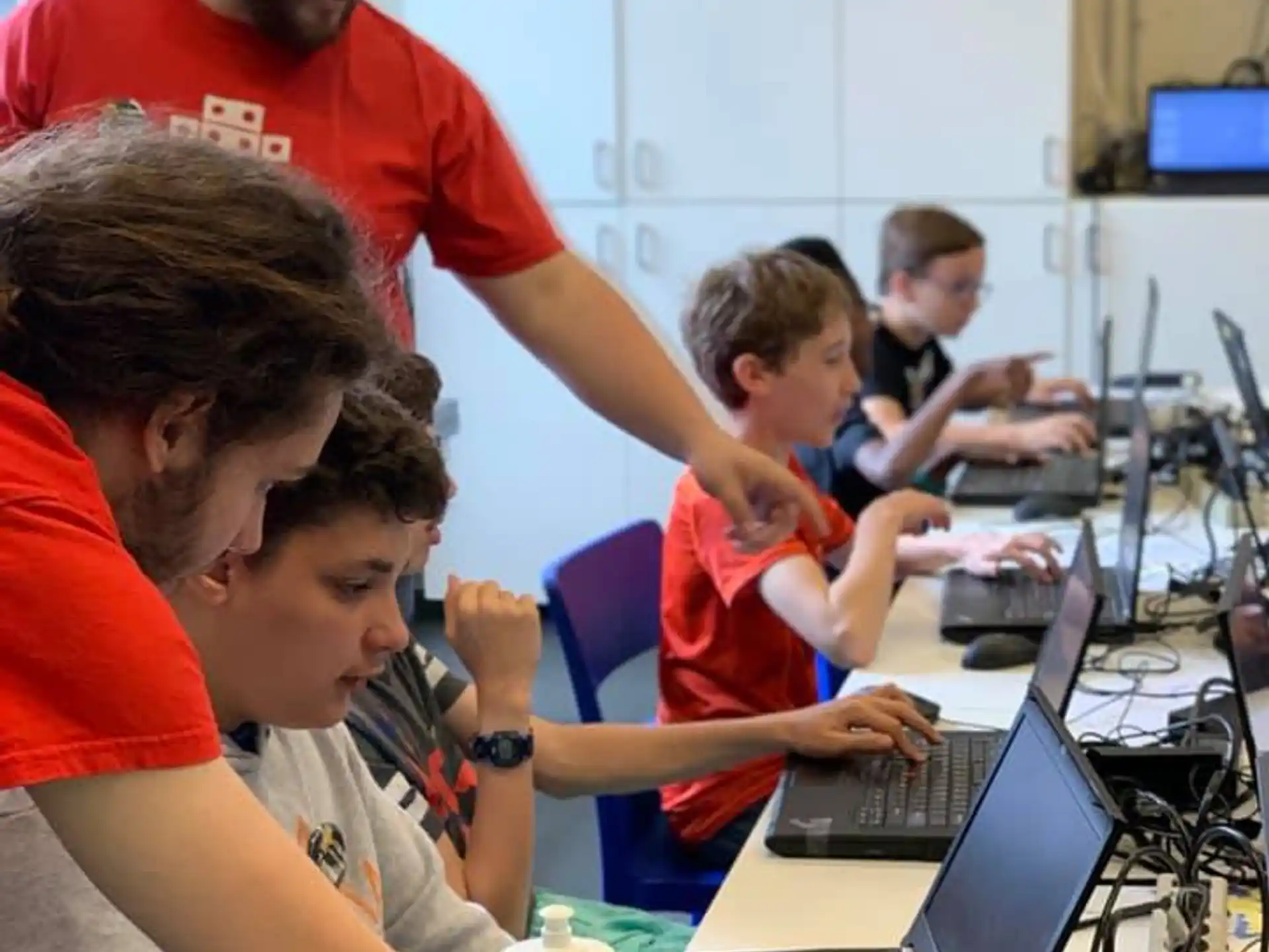 a group of people working on laptops