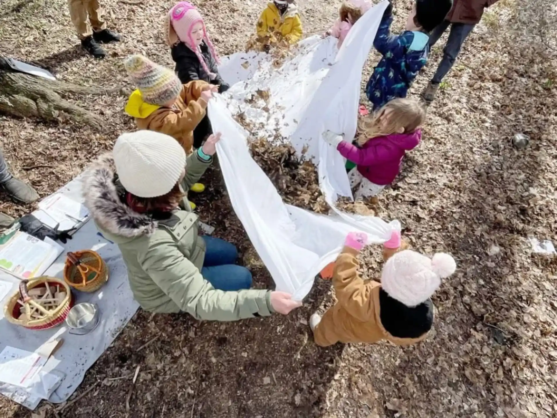 a group of people sitting on the ground eating food
