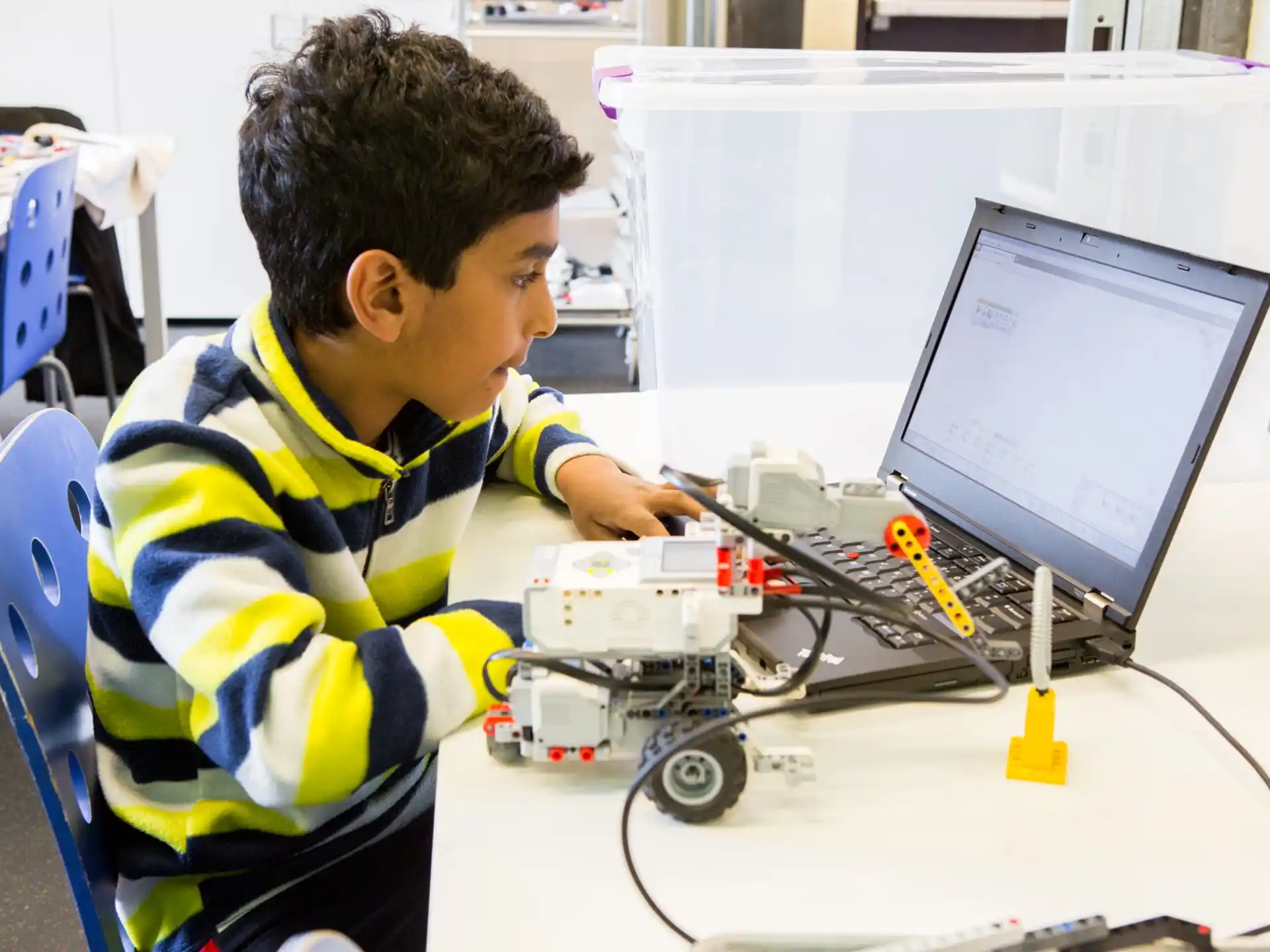 a young boy working on a computer